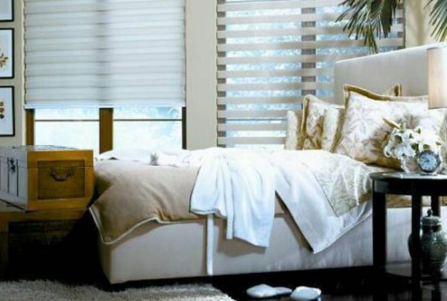 Custom zebra blinds in a Mississauga bedroom, featuring alternating sheer and opaque fabric for enhanced privacy and adjustable light control.