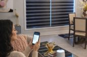 Smartphone controlling motorized blinds in a modern smart home