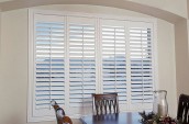 "Dining room with white California vinyl shutters in Toronto and Southern Ontario."