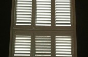 Tall window with custom shutters installed by Shutter Outlet in Maple, Ontario.