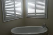 Bathroom with custom white shutters installed by Shutter Outlet in Tottenham, Ontario.