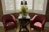 Custom shutters installed in a sophisticated Richmond Hill, Ontario, living room with classic furniture and decor.